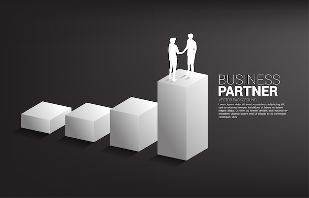 Silhouette of businessman handshake on growing graph. Concept of team work partnership and cooperation.