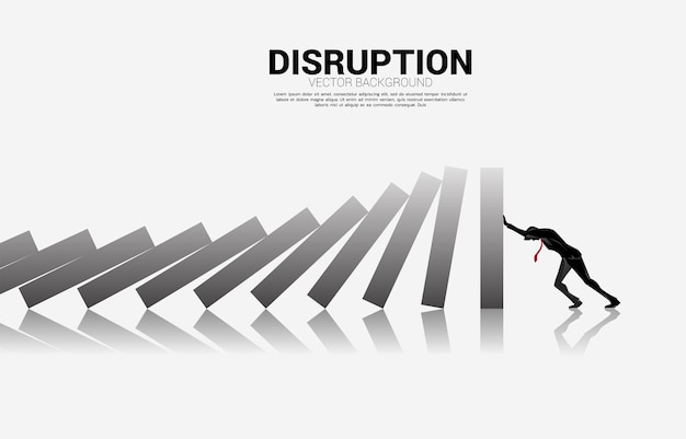 Silhouette of businessman pushing for stop falling of domino. business concept of try to stop the domino effect