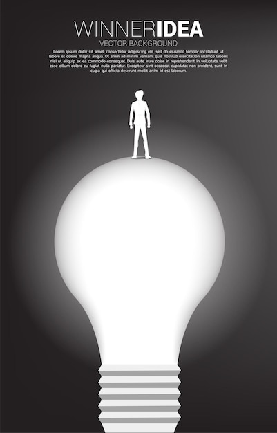 Silhouette of businessman standing on light bulb