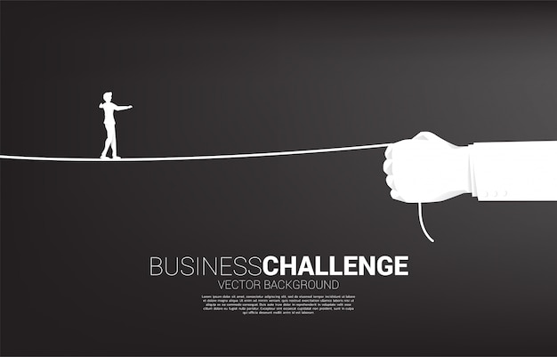 Silhouette of businessman walk rope in businessman hand. Concept of Business challenge and career path.