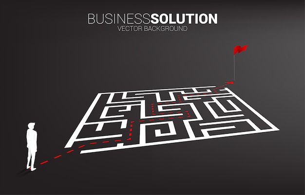 Vector silhouette of businessman with route path to exit the maze to flag