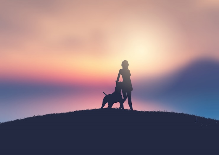 Vector silhouette of a female and her dog against a sunset landscape
