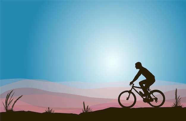 Silhouette of man Rides Bicycle on Hill