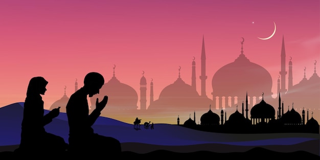 Silhouette muslim man and woman making a supplication salahsitting on desert sand