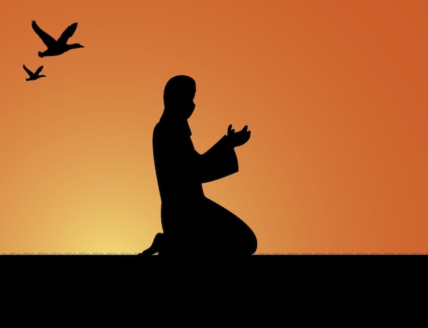 Silhouette of a Muslim praying during sunset.