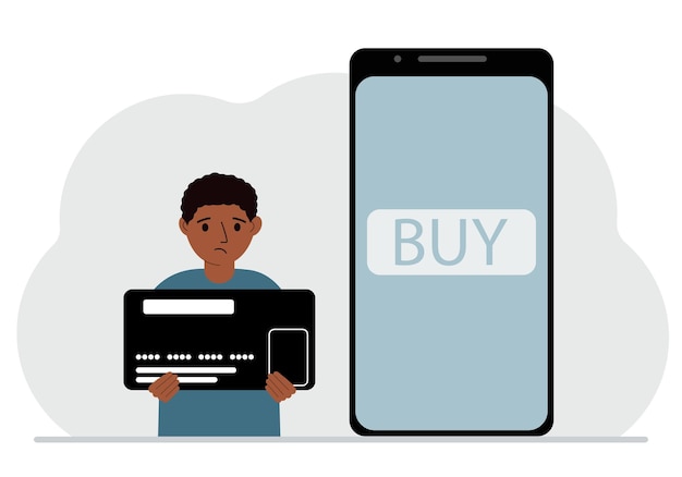 A small boy holds a credit card in his hand and a large mobile phone nearby The concept of bank payment online purchase children's credit card