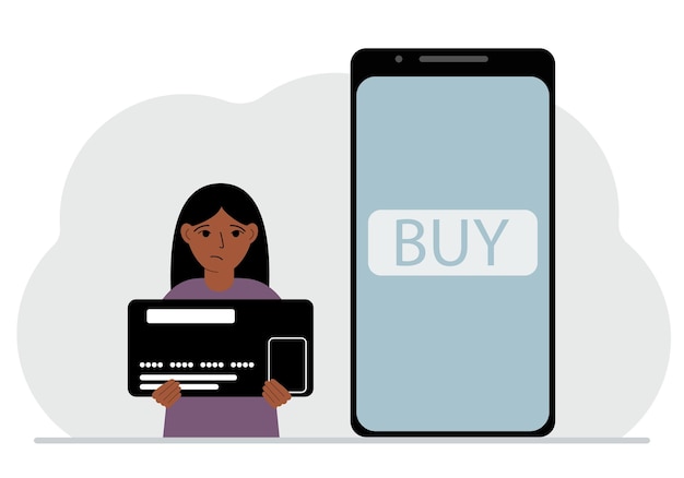 A small girl holds a credit card in his hand and a large mobile phone nearby The concept of bank payment online purchase children's credit card