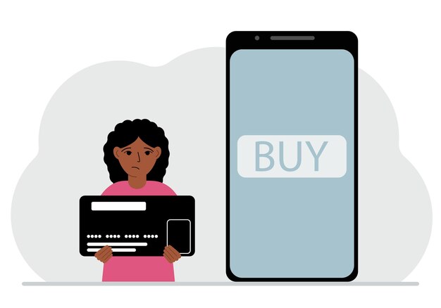 A small girl holds a credit card in his hand and a large mobile phone nearby The concept of bank payment online purchase children's credit card