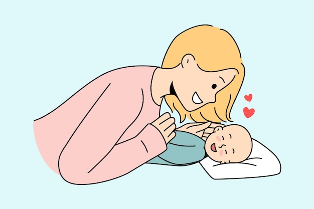 Smiling mom play with newborn baby