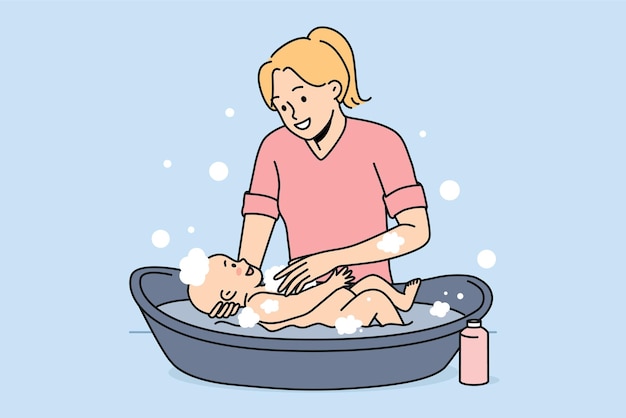 Smiling mother washing newborn baby