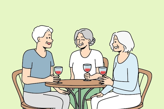 Smiling old people sit in cafe drink wine