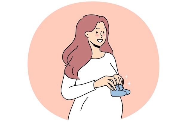 Smiling pregnant woman with baby shoes