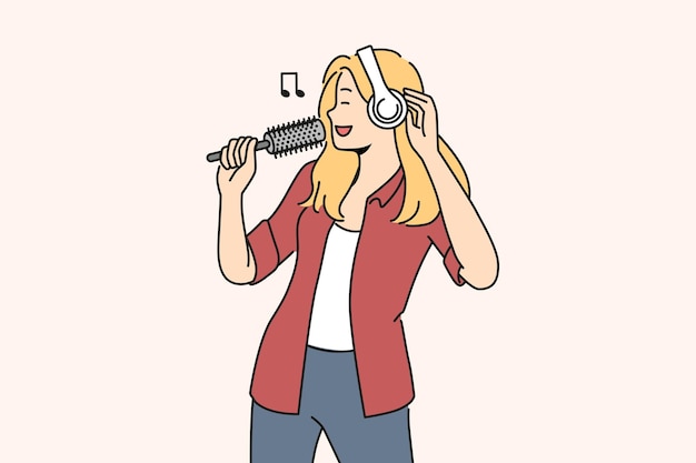 Smiling woman in earphones sing in hairbrush