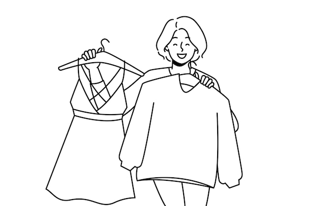 Smiling woman holding clothes on hangers