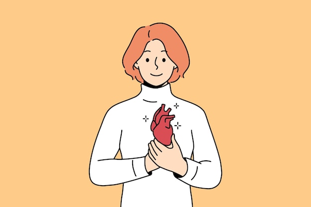 Smiling woman holding heart in hands