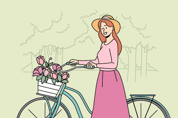 Smiling woman walking bike with flowers in park