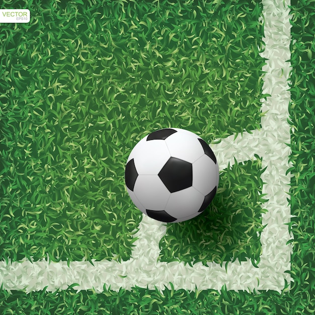 Soccer football ball in corner area of soccer field with green grass pattern texture background.