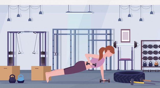 sport vrouw doen halters plank oefening meisje tillen gewicht uit te werken in de sportschool crossfit training gezonde levensstijl concept plat modern healthclub studio interieur horizontaal