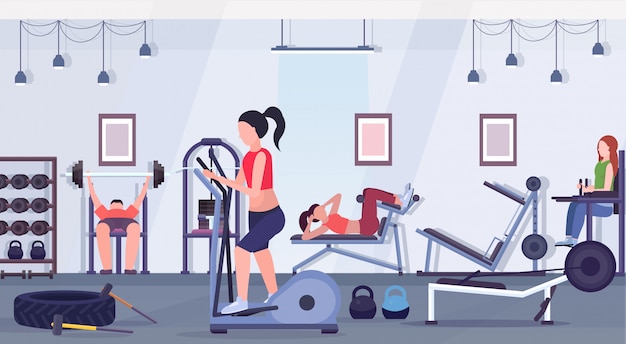 sportieve mensen die oefeningen doen mannen vrouwen die samen op opleidingsapparaten in het concept van de de gezonde levensstijlconcept van de gymnastiektraining uitwerken modern health club studio binnenlands horizontaal