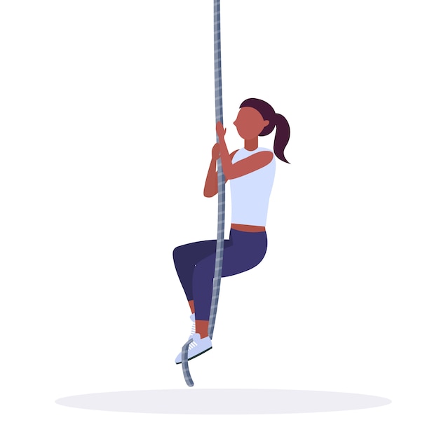 Sporty woman doing rope climbing exercise girl training in gym
cardio crossfit workout healthy lifestyle concept white background
full length