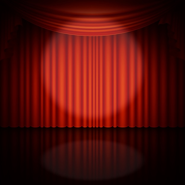 Spotlight on stage and red curtain.