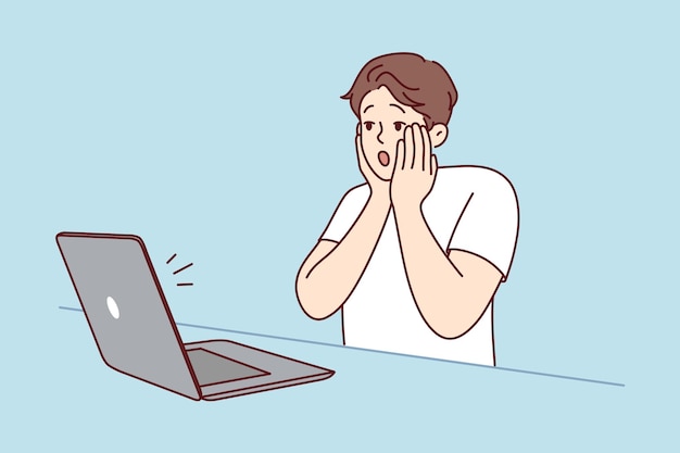 Stunned man shocked by news on computer