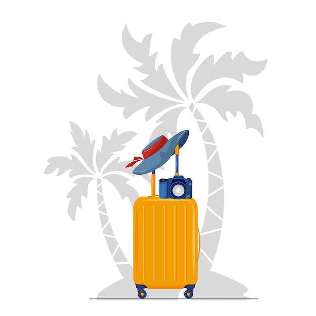 Suitcase with summer hat and camera under the palm trees