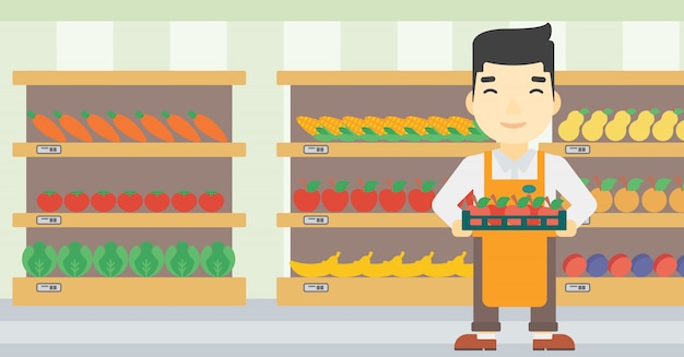 Supermarket worker with box full of apples.