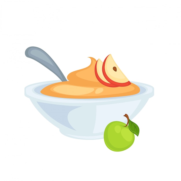 Сладкое вкусное яблочное пюре в глубокой миске с ложкой