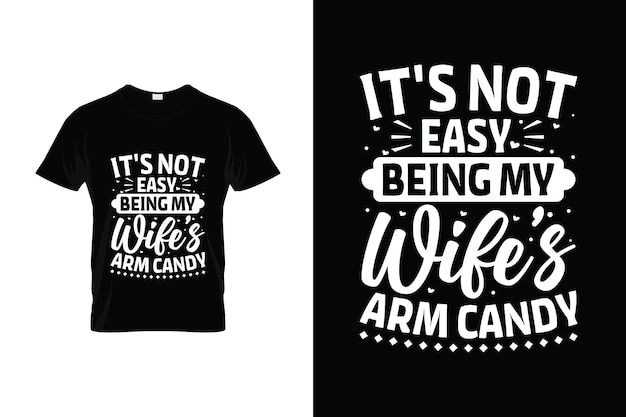 A t - shirt that says it's not easy being my wife's arm candy.