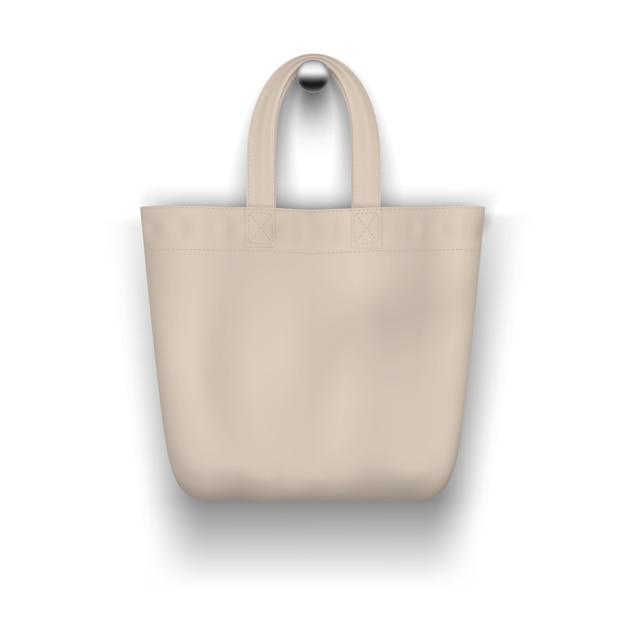 Vettore tote bag beige in tessuto appeso al muro realistico per lo shopping.