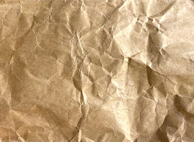 Texture of beige crumpled paper background