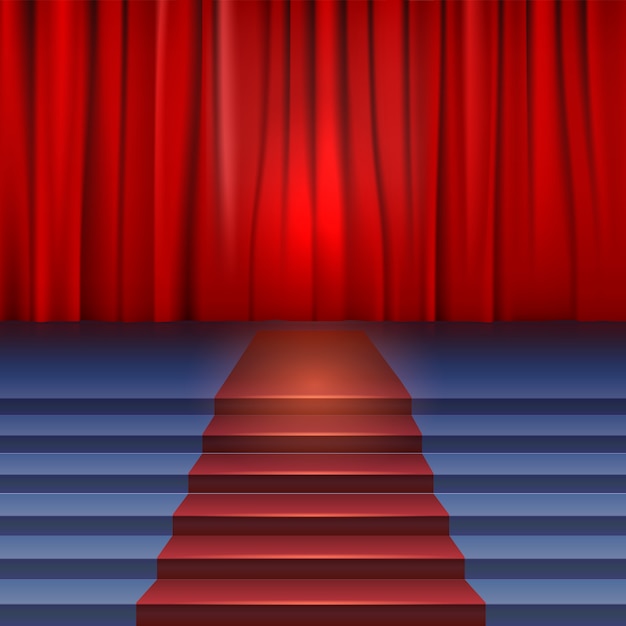 Theater stage with red curtain and carpet.