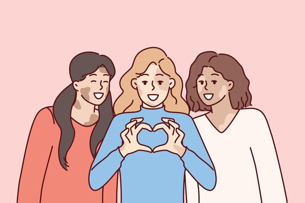 Three women with vitiligo syndrome are smiling demonstrating heart gesture as sign of selflove