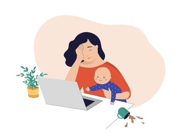 Tired mom trying to work holding baby in her arms
