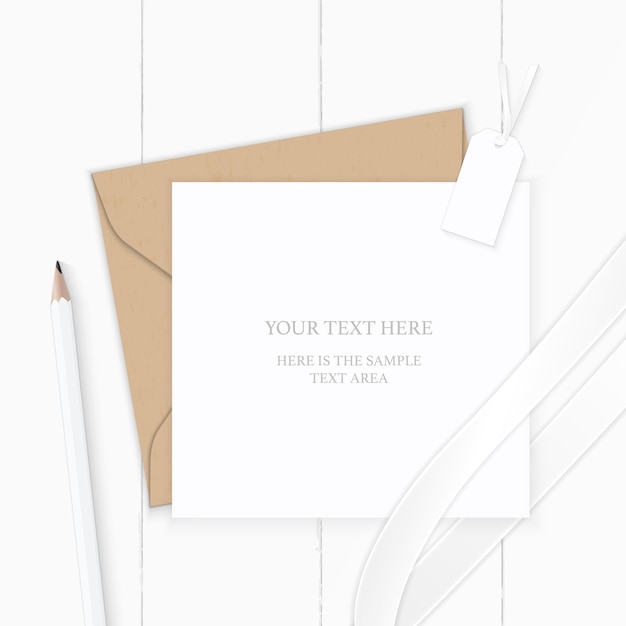 Top view elegant white composition letter kraft paper envelope pencil tag and silk ribbon on wooden background.