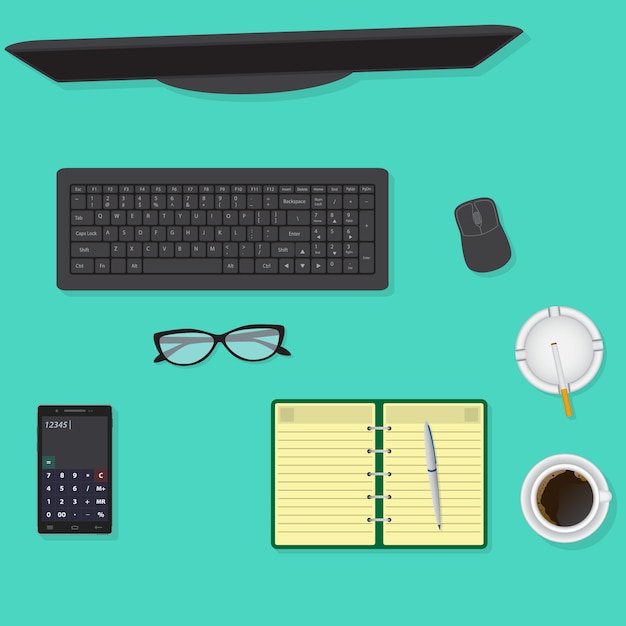 Top view of office desk including monitor, keyboard and mouse, glasses, cup of coffee.