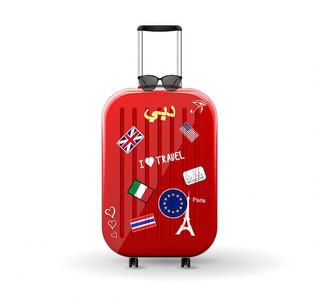 ステッカー付きトラベルバッグ。上にサングラスをかけた赤い光沢のあるスーツケース。世界への旅。