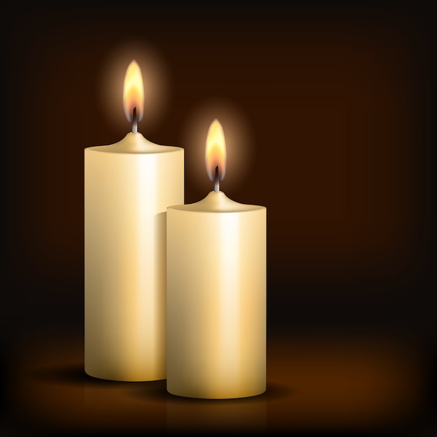 Two burning candles on black table.