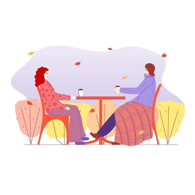 Two girls, women, sitting at a table outside with coffee, cafe, conversation, autumn, warm clothes