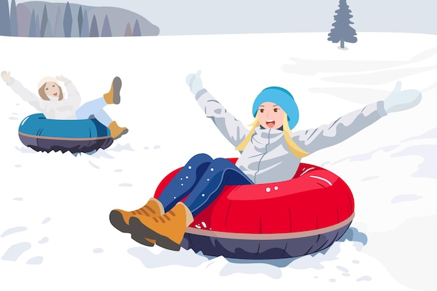 two joyful girlfriends ride tubing in winter from the mountain