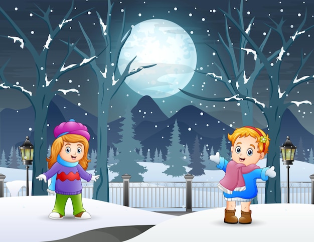 Two little girls playing outside in winter night