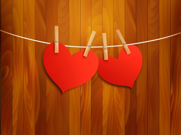 Two red loving hearts hanging on a rope