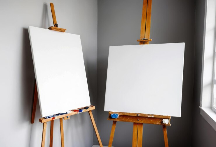 Vector two white canvass with paint on them are on a wooden easel