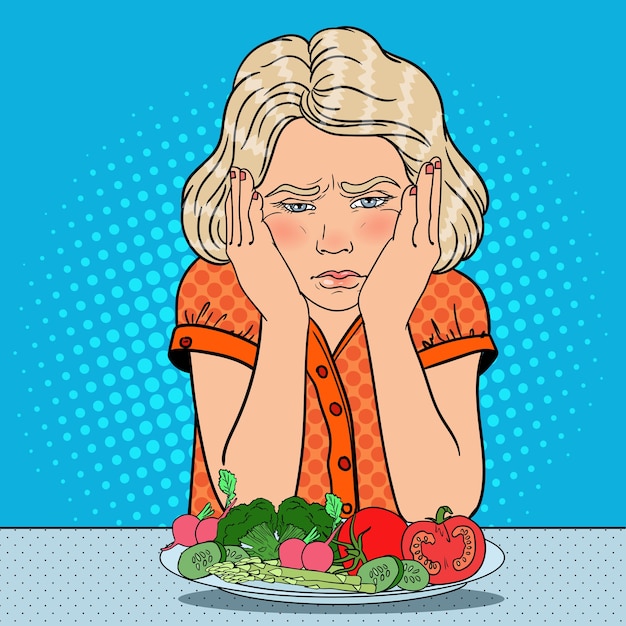 Unhappy girl with plate of fresh vegetables