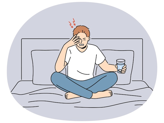 Unhealthy man sit on bed suffer from headache