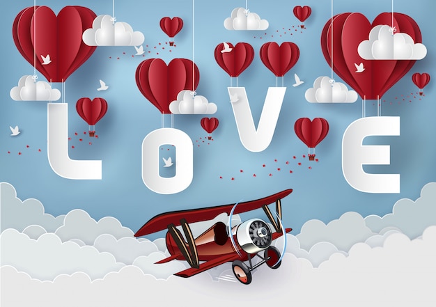 バレンタインデーのコンセプトです。空に浮かぶ赤い風船にはloveという文字があります。ペーパーアートスタイル