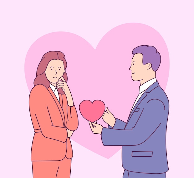 Valentines day with young couple in love. Young man gives heart-shaped card to smiling woman.