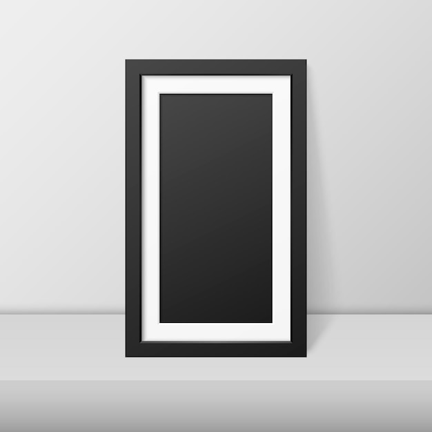 Vector vector 3d realistic modern interior black blank vertical wooden poster picture frame on table shelf closeup on white wall mockup empty poster frame design template for mockup presentation