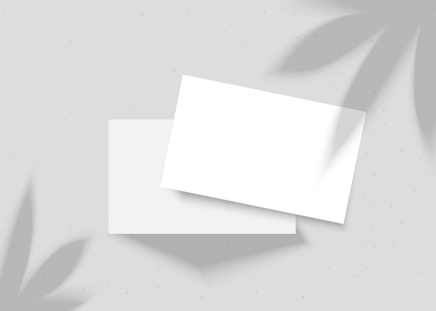 Vector mockup van visitekaartjes met plantenschaduw Twee visitekaardjes op een grijze achtergrond